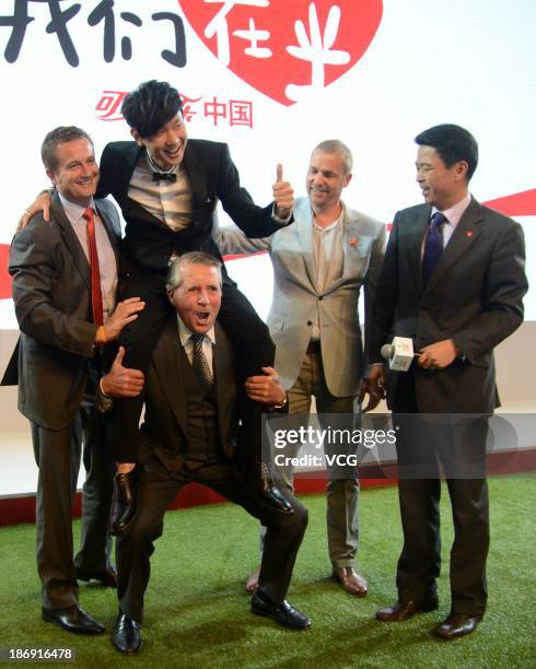 Gary Player carries singer JJ Lin on his shoulder during Gary Player Invitational Charity Dinner at Shangri-La Hotel on November 4, 2013 in Shanghai,...