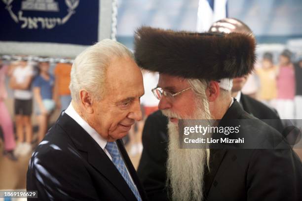 Israeli President Shimon Peres speaks to an Ultra Orthodox Jewish man , on October 01, 2007 in Jerusalem, Israel.