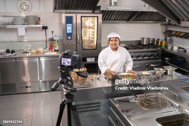 a female chef recording a cookery video - virtual lunch stock pictures, royalty-free photos & images