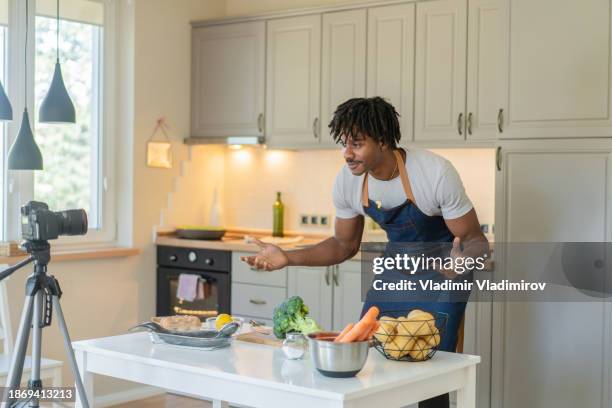 vlogging a cooking tutorial from a domestic kitchen - tripod fish stock pictures, royalty-free photos & images