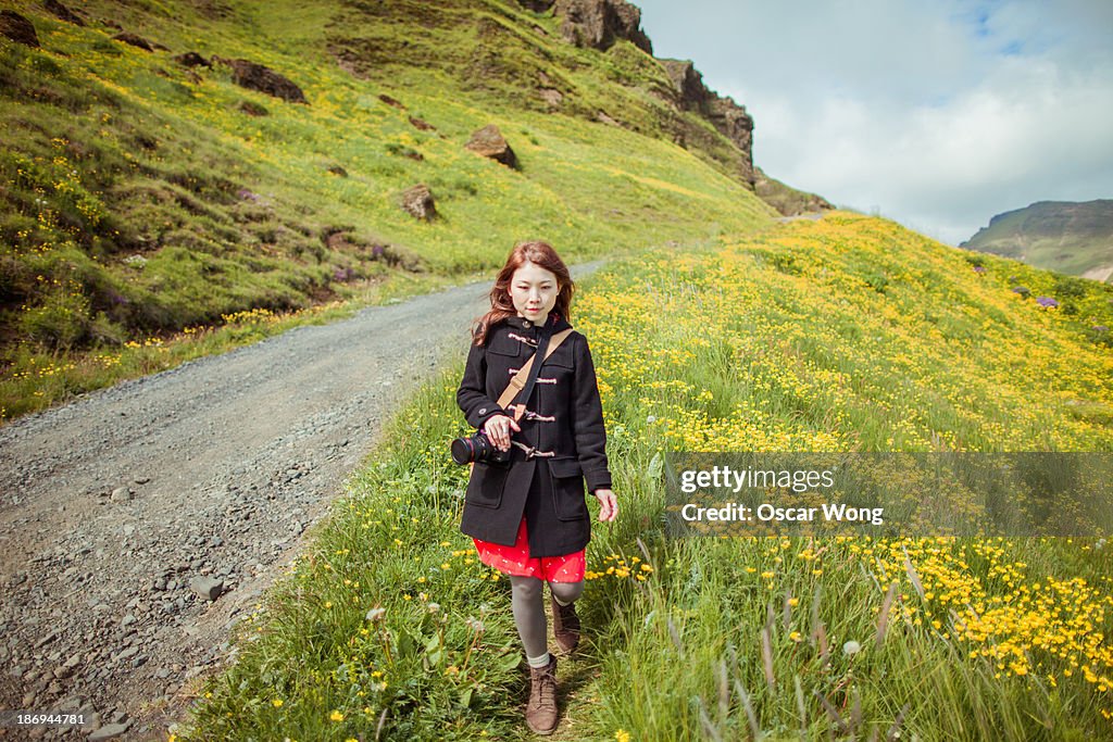 A young girl is walking on a mountain