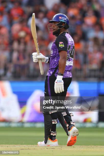 Chris Jordan of the Hurricanes raises the bat for his 50 runs during the BBL match between Perth Scorchers and Hobart Hurricanes at Optus Stadium, on...