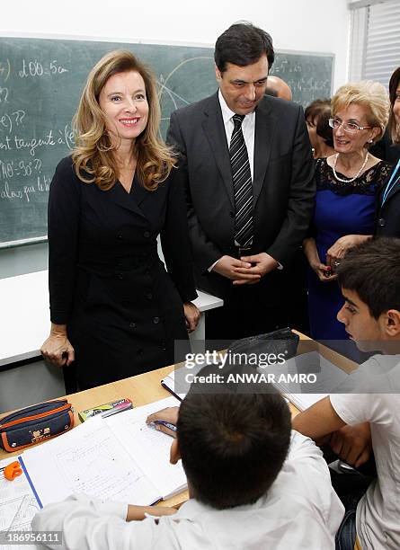 French President's companion Valerie Trierweiler , flanked by Lebanese Minister of Education Hassan Diab, visits a public school that is taking in...