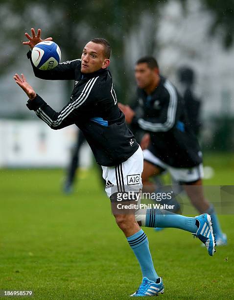 Aaron Cruden of the All Blacks takes a pass during a New Zealand All Blacks training session at the Rugby Club Suresnois on November 5, 2013 in...