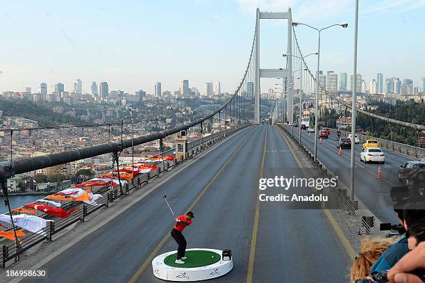 World number one golfer Tiger Woods looks after the hit the ball from East to West on Bosphorus Bridge that connects continents of Europe and Asia on...