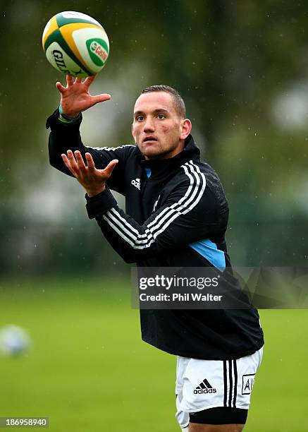 Aaron Cruden of the All Blacks takes a pass during a New Zealand All Blacks training session at the Rugby Club Suresnois on November 5, 2013 in...