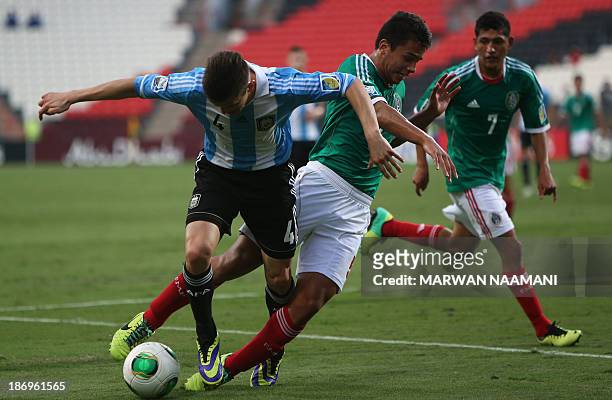 Osvaldo Rodriguez of Mexico vies for the ball against Nicolas Tripichio of Argentina during the two teams' semi-final of the FIFA U-17 World Cup at...