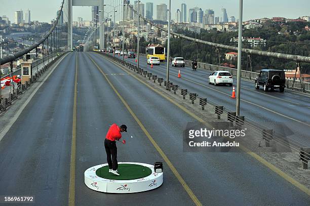 The world number one golfer Tiger Woods hits the ball from East to West on Bosphorus Bridge that connects continents of Europe and Asia on the...