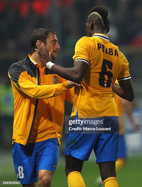 Paul Pogba of Juventus celebrates with his team-mate Claudio Marchisio after scoring the opening goal during the Serie A match between Parma FC and...