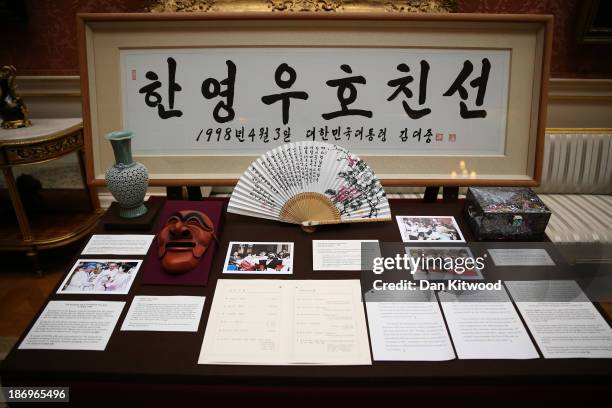 Fan gifted to Queen Elizabeth II by Mr. Ry Young-ha during her visit to Hahoe Village in Korea and a Yangban mask that was presented to Queen...