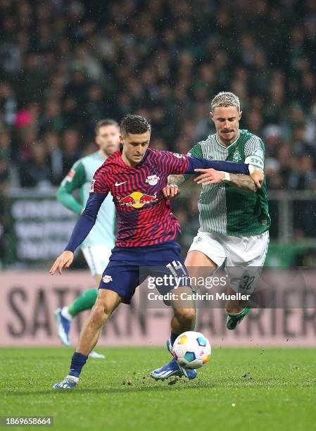 Christoph Baumgartner of RB Leipzig is challenged by Marco Friedl of Werder Bremen during the Bundesliga match between SV Werder Bremen and RB...