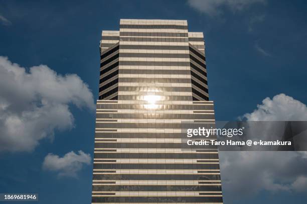 sun on city building in bangkok of thailand - sun city center stock pictures, royalty-free photos & images