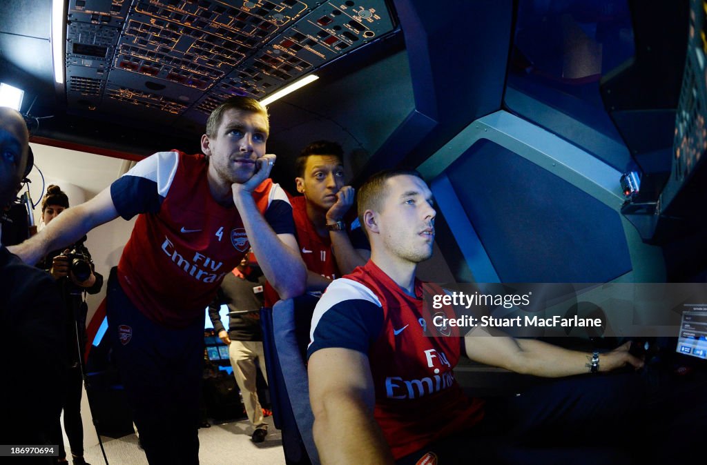 Arsenal Players Mesut Ozil, Per Mertesacker and Lukas Podolski visit the Emirates Aviation Experience