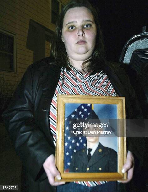 Katherine Riley holds a photo of her brother, Sgt. James Riley, who was captured during fighting in Iraq, March 24, 2003 in Pennsauken, New Jersey....