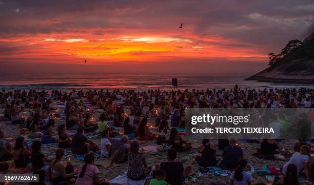 People attend a massive yoga class during the "Yoga ao Sol Nascer" event, at Recreio dos Bandeirantes beach in Rio de Janeiro, Brazil, on December...