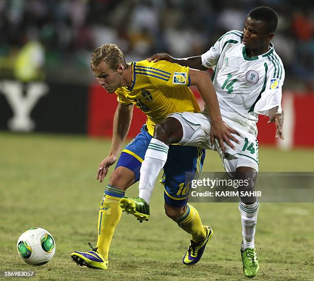 Chidiebere Nwakali of Nigeria fights for the ball against Gustav Engvall of Sweden during the two teams' semi-final in the FIFA U-17 World Cup in...