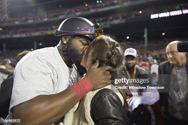 World Series: Boston Red Sox David Ortiz victorious, kissing his wife, Tiffany Ortiz, on field after winning Game 6 and championship series vs St....