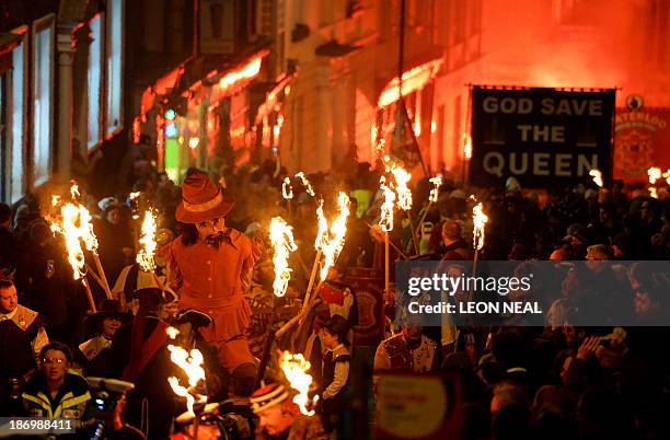 Bonfire societies parade through the streets with an effigy of Guy Fawkes during the Bonfire Night celebrations on November 5, 2013 in Lewes, Sussex...