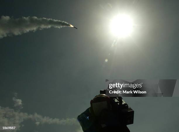 Cameraman films a Tomahawk cruise missile as it flies toward Iraq after being launched from the AEGIS guided missile cruiser USS San Jacinto March...