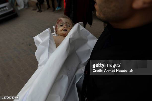 Person holds one-year-old and three-month-old Nisreen Jundiyeh, who was killed by Israeli air strikes on the city of Khan Yunis on December 20, 2023...