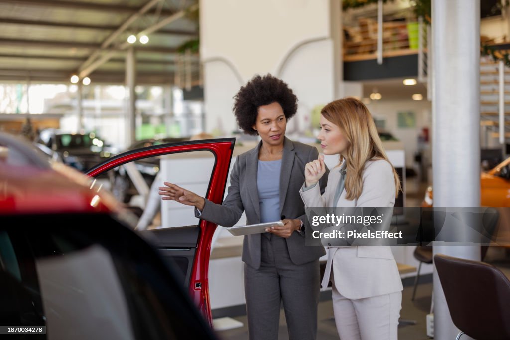 Female Seller Showing Brand New Car to a Customer