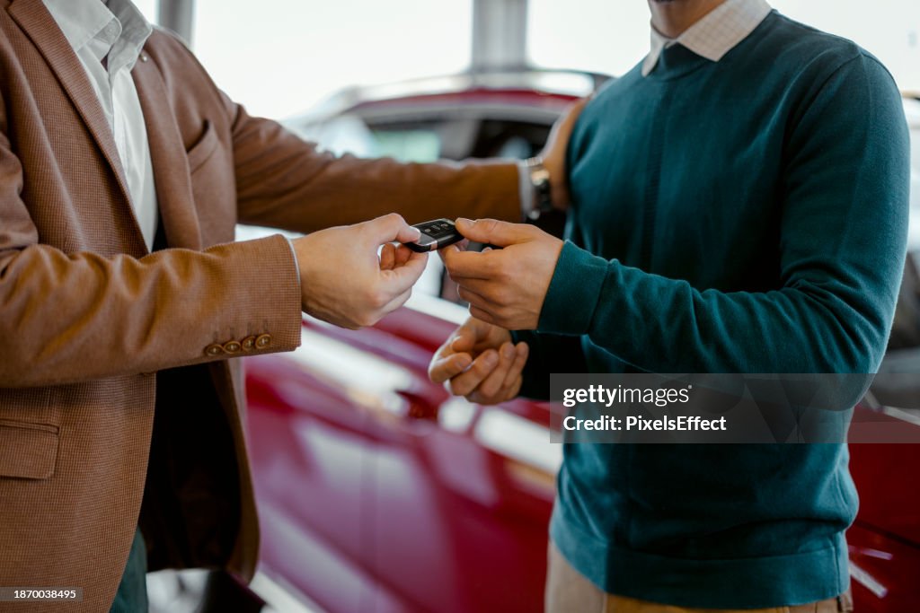 Cardealer Giving Car Key to Customer