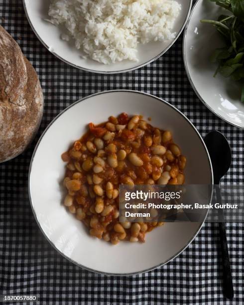 vegan meal with; cannellini beans, rice pilaf, and greens - pilau rice stock pictures, royalty-free photos & images