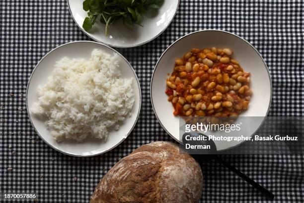 vegan meal with; cannellini beans, rice pilaf, and greens - pilau rice stock pictures, royalty-free photos & images