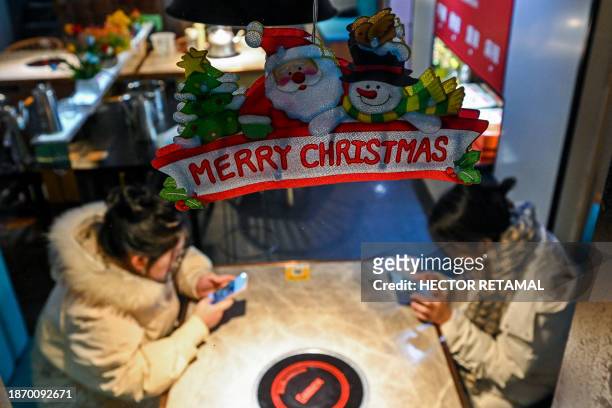 People are seen in a restaurant in the Jing'an district in Shanghai on December 23, 2023.