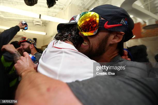 Jarrod Saltalamacchia and John Lackey of the Boston Red Sox celebrates in the locker room after defeating the St. Louis Cardinals 6-1 in Game Six of...