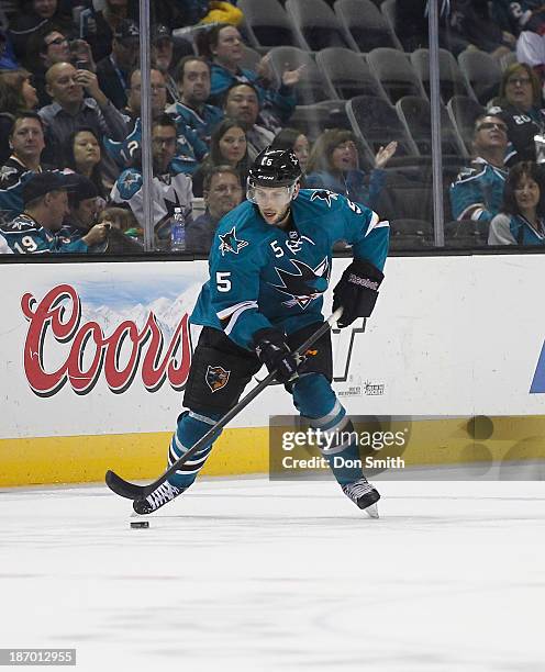 Jason Demers of the San Jose Sharks handles the puck against the Calgary Flames during an NHL game on October 19, 2013 at SAP Center in San Jose,...