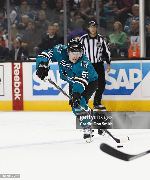 Matt Irwin of the San Jose Sharks passes the puck against the Calgary Flames during an NHL game on October 19, 2013 at SAP Center in San Jose,...