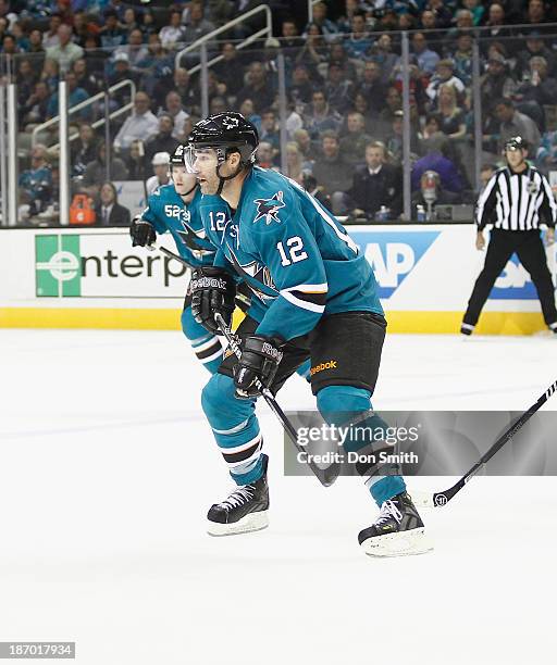 Patrick Marleau of the San Jose Sharks skates after the puck against the Calgary Flames during an NHL game on October 19, 2013 at SAP Center in San...