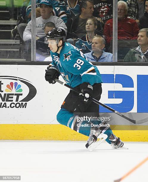 Logan Couture of the San Jose Sharks skates after the puck against the Calgary Flames during an NHL game on October 19, 2013 at SAP Center in San...