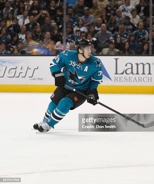 Logan Couture of the San Jose Sharks skates after the puck against the Calgary Flames during an NHL game on October 19, 2013 at SAP Center in San...