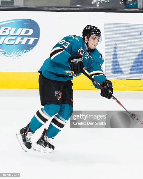 Matthew Nieto of the San Jose Sharks passes the puck against the Calgary Flames during an NHL game on October 19, 2013 at SAP Center in San Jose,...