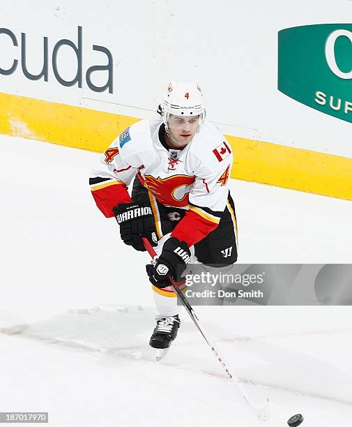 Kris Russell of the Calgary Flames skates after the puck against the San Jose Sharks during an NHL game on October 19, 2013 at SAP Center in San...