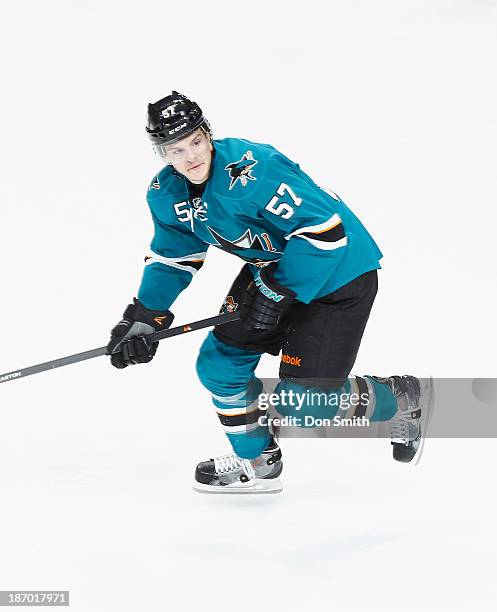 Tommy Wingels of the San Jose Sharks skates after the puck against the Calgary Flames during an NHL game on October 19, 2013 at SAP Center in San...