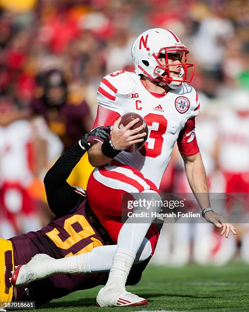 Alex Keith of the Minnesota Golden Gophers sacks Taylor Martinez of the Nebraska Cornhuskers during the game on October 26, 2013 at TCF Bank Stadium...