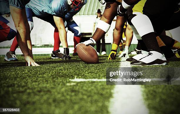 two football teams meet at the line of scrimmage - yard line stock pictures, royalty-free photos & images