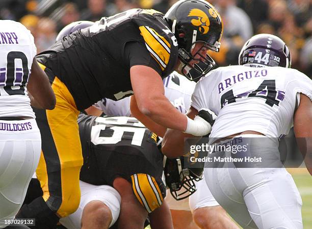 Offensive lineman Brett Van Sloten of the Iowa Hawkeyes battles during the first quarter with linebacker Chi Chi Ariguzo of the Northwestern Wildcats...