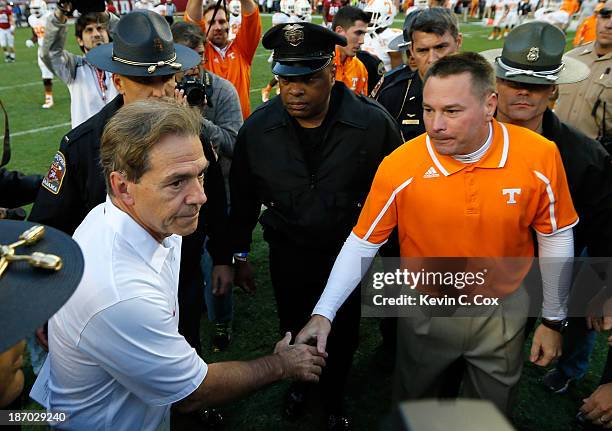 Head coach Nick Saban of the Alabama Crimson Tide shakes hands with head coach Butch Jones of the Tennessee Volunteers at Bryant-Denny Stadium on...