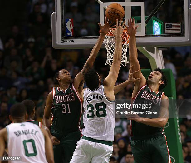 Milwaukee Bucks power forward John Henson and Milwaukee Bucks center Zaza Pachulia defends as Boston Celtics center Vitor Faverani goes up for a shot...