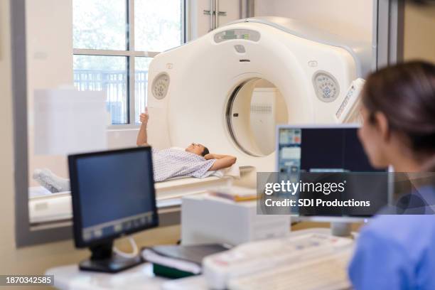 radiographer, in control room, talks to patient - mri technician stock pictures, royalty-free photos & images