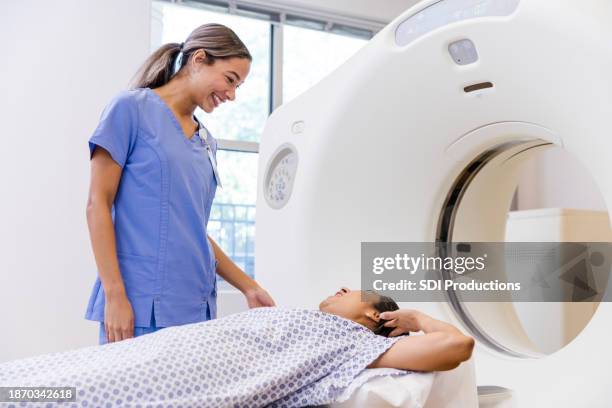 caring radiographer listens to female patient - ct scan stock pictures, royalty-free photos & images