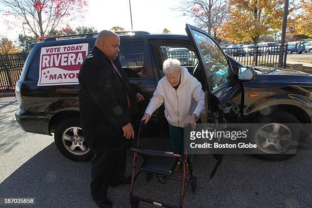 Ninety-two year old Elizabeth Fallisi of Lawrence gets a lift to the polling station from mayoral candidate Daniel Rivera on Tuesday morning....