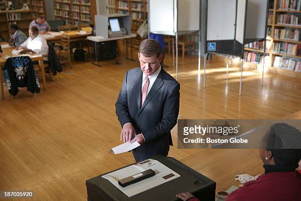 Ballot in hand, Rep. Marty Walsh voted with his partner Lorrie Higgins and her daughter Lauren Campbell at the Cristo Rey School, 100 Savin Hill Ave.