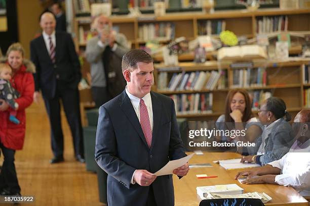 Ballot in hand, Rep. Marty Walsh voted with his partner Lorrie Higgins and her daughter Lauren Campbell at the Cristo Rey School, 100 Savin Hill Ave.