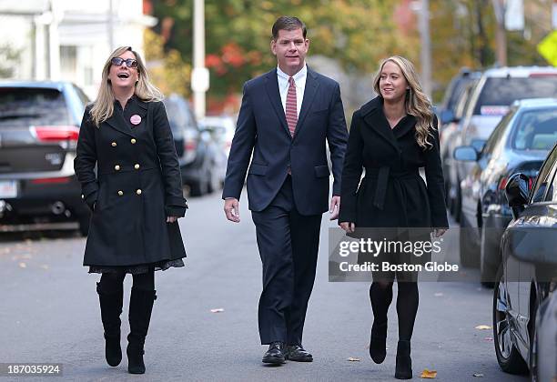 Walking up to the location to vote, Rep. Marty Walsh voted with his partner Lorrie Higgins, left, and her daughter Lauren Campbell at the Cristo Rey...