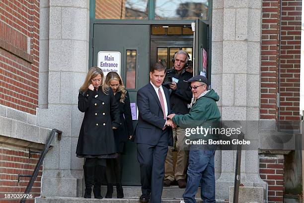 Shaking hands on his way out, Rep. Marty Walsh voted with his partner Lorrie Higgins, far left, and her daughter Lauren Campbell at the Cristo Rey...